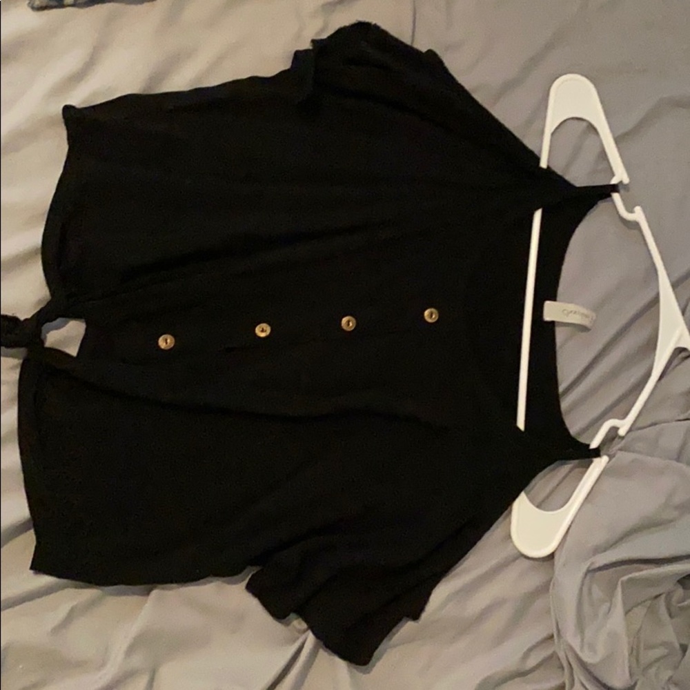 a black shirt with gold buttons